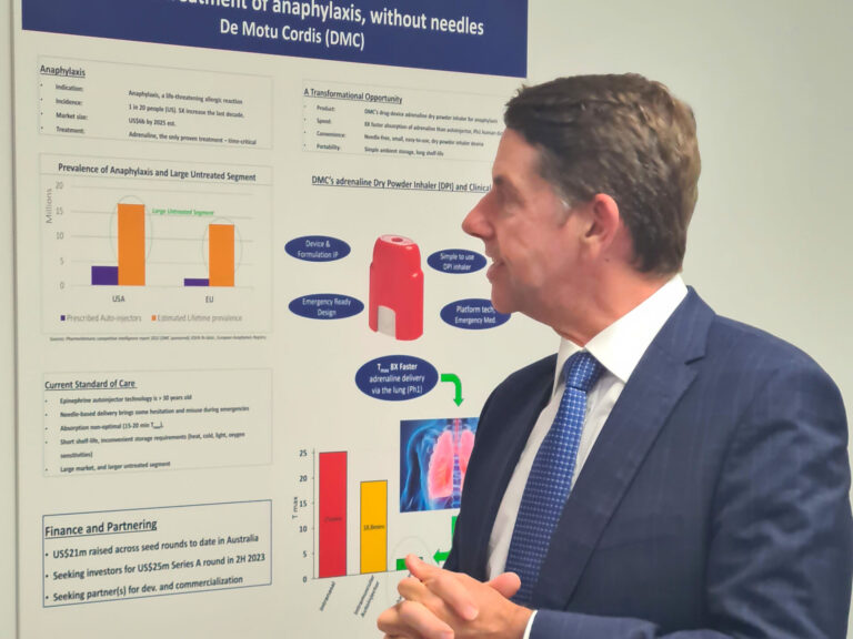The Honourable Cameron Dick MP looking at a poster