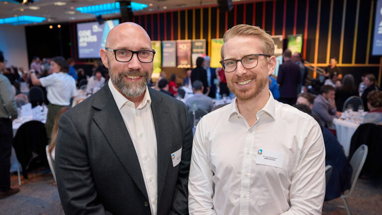 Two DMC employees smiling together at the awards ceremony